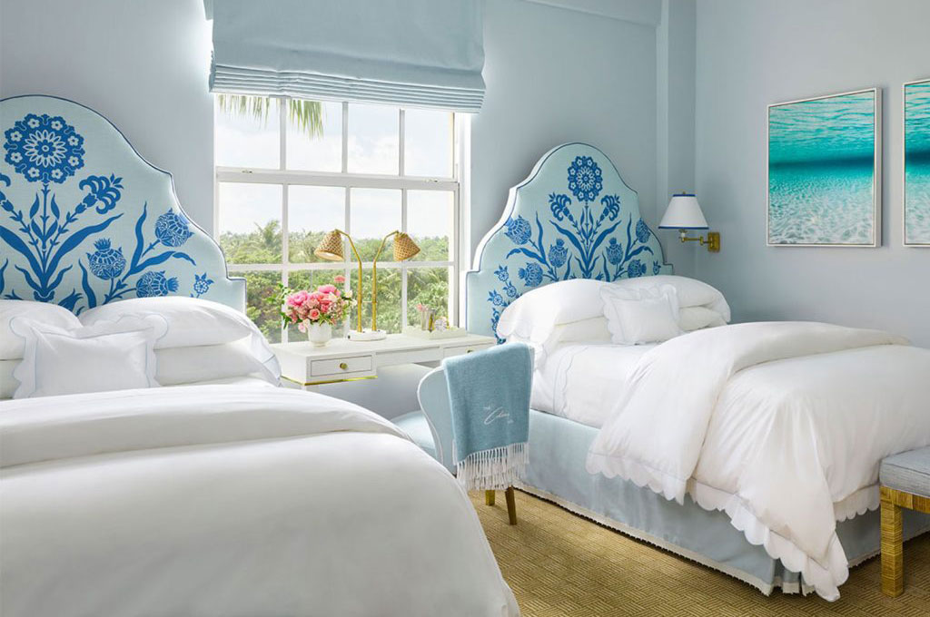 twin beds with blue upholstered headboards