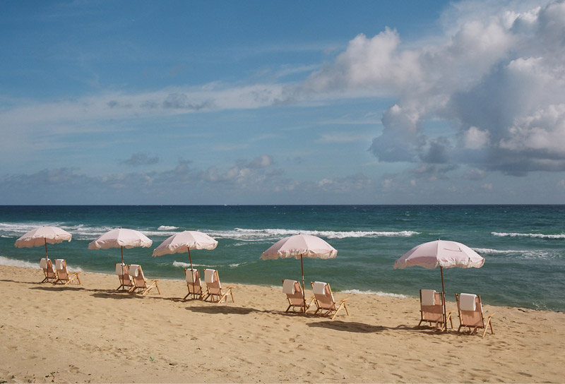 West Palm Beach front with chairs and umbrellas lined up on the sand by the ocean