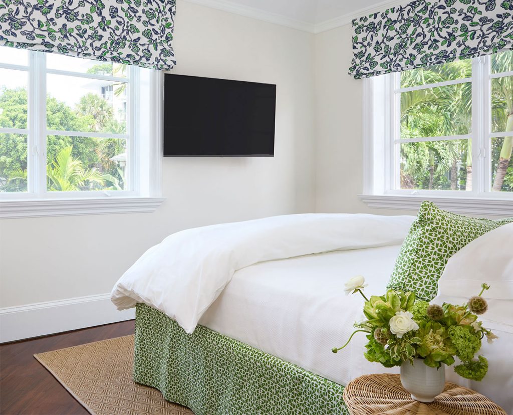 Bungalow bedroom with view of palm trees.