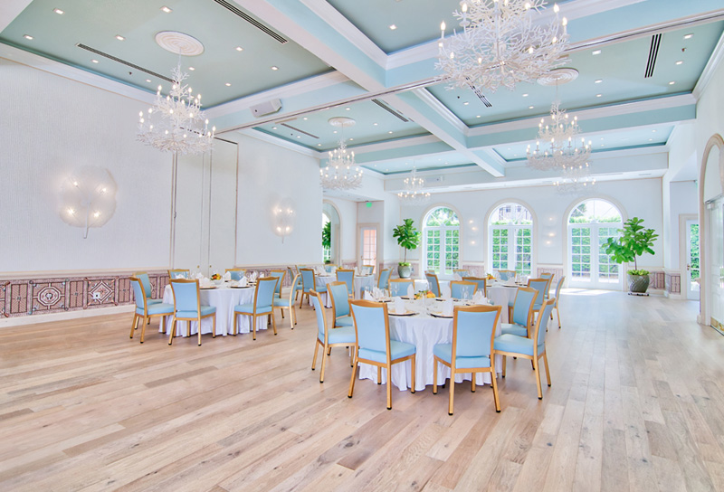 ballroom with round tables and blue chairs