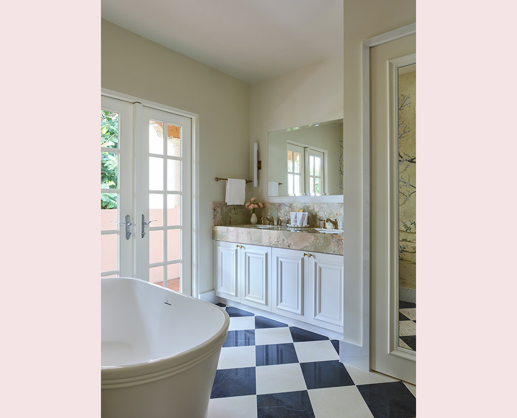 checkered floor bathroom with tub and sink and french doors