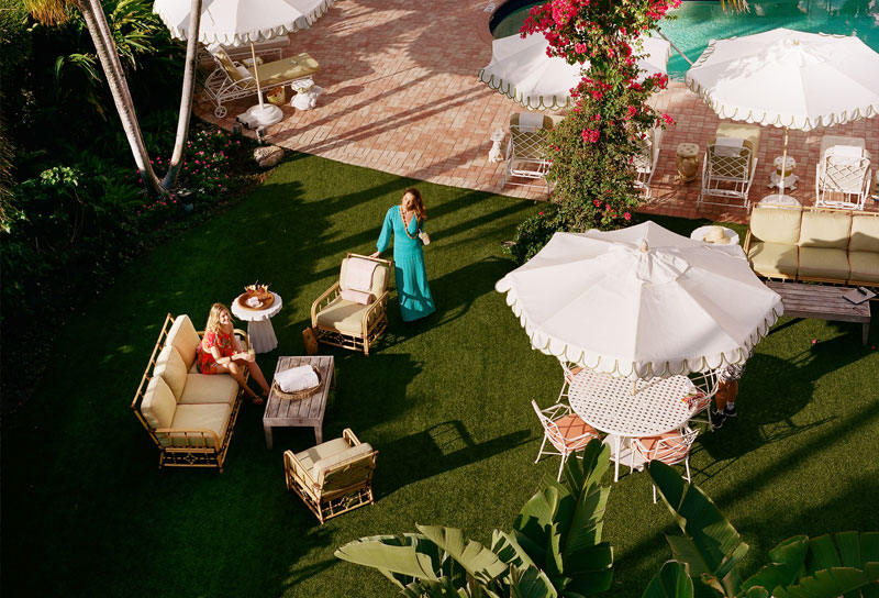 green lawn with lounge furniture and umbrella