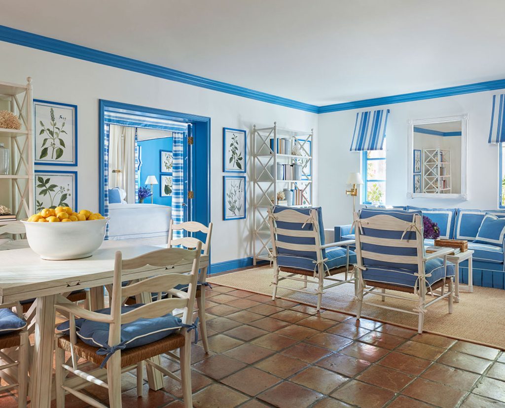 Dining and sitting area with blue accents throughout room.