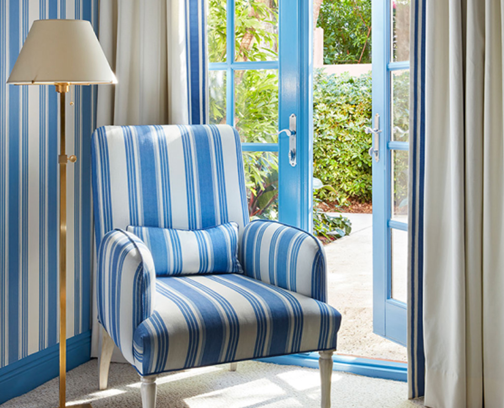 lounge chair and lamp next to patio door