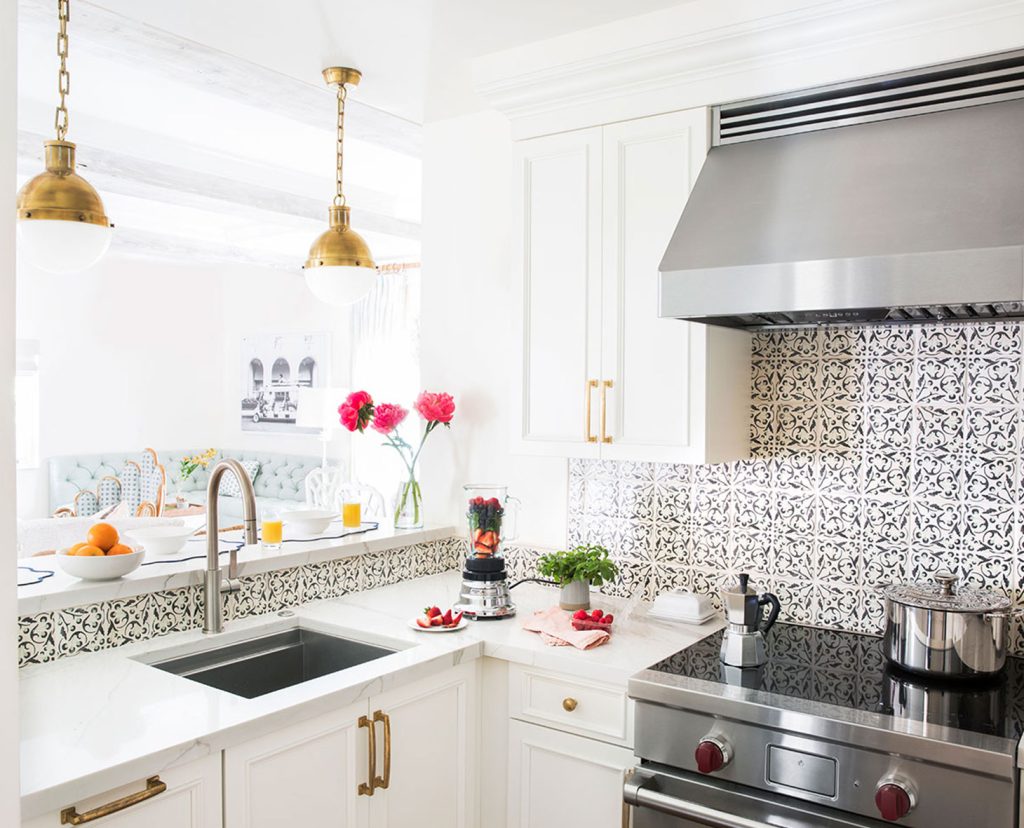 White kitchen with decorative backsplash tile.