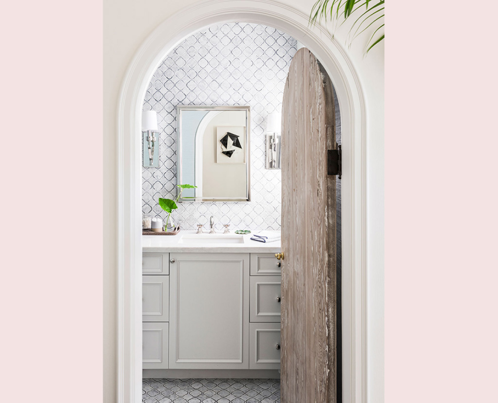 bathroom entry with arched wooden door
