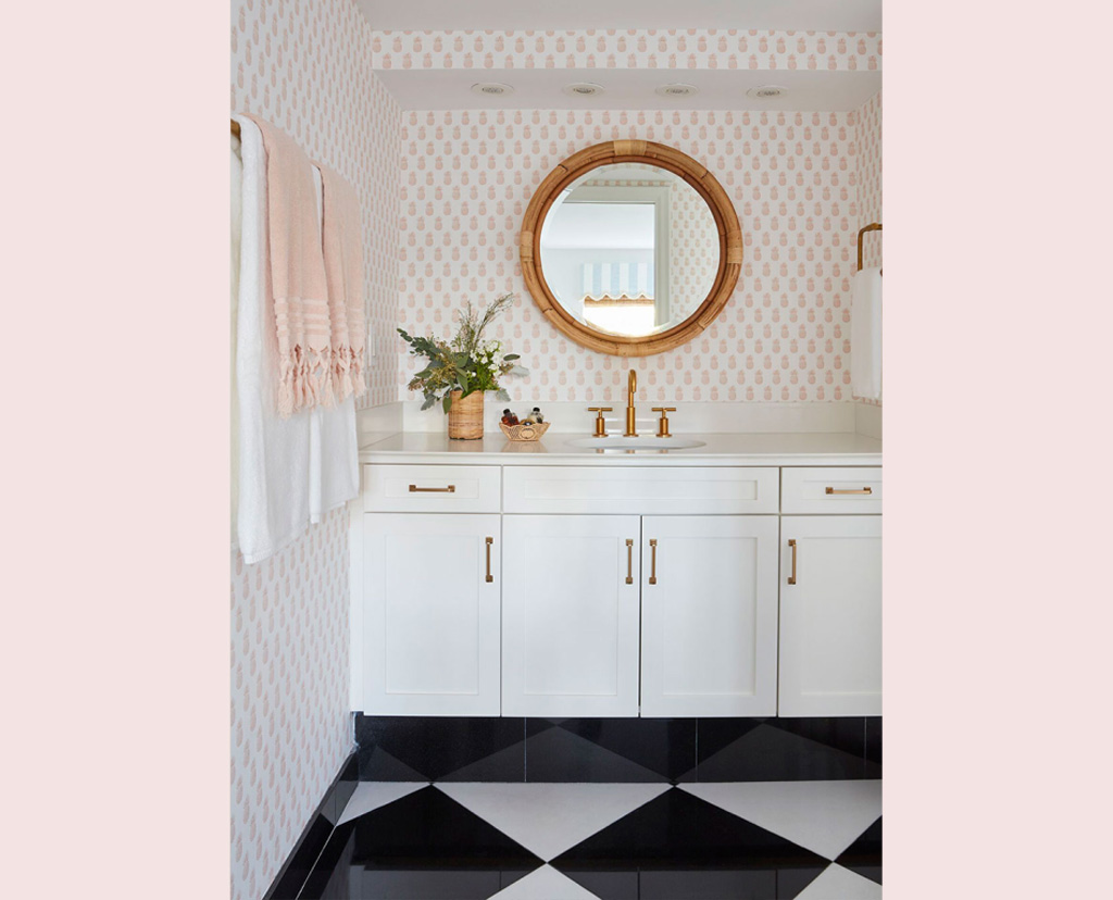 bathroom with checkered floor and round mirror above sink