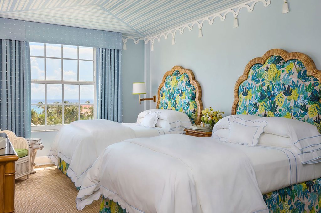 light blue guest room with turquoise headboards